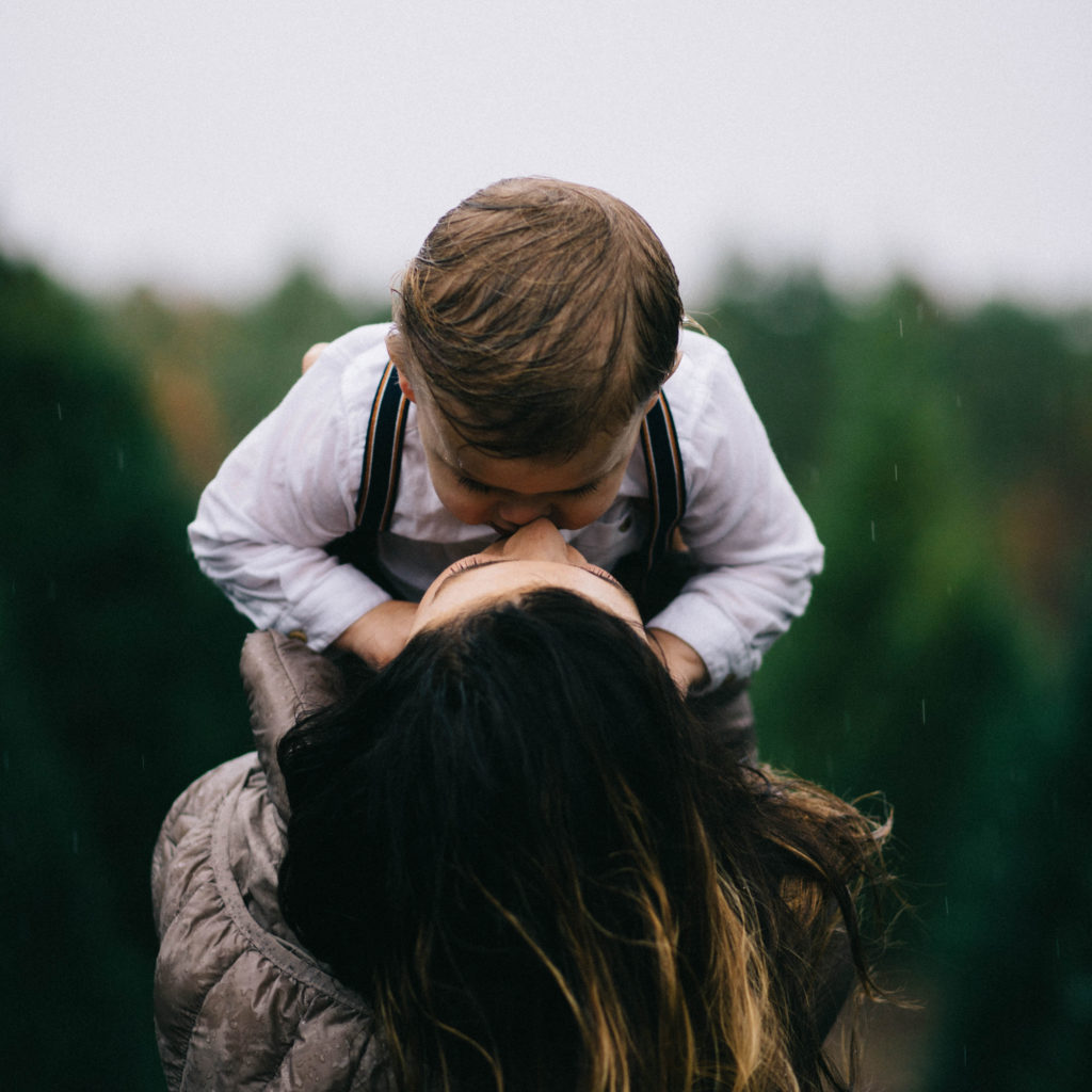 Mom and little son kissing