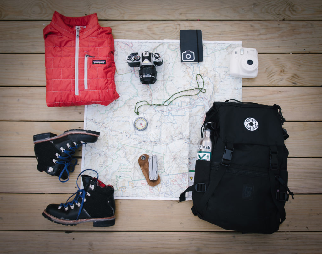 Hiking gear laid out on map