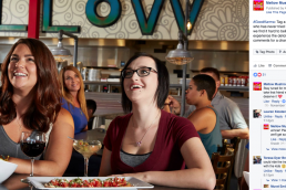 Women smiling with pizza and drinks