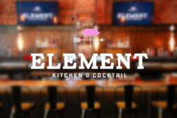 Blurry restaurant with Element Kitchen & Cocktail logo on top